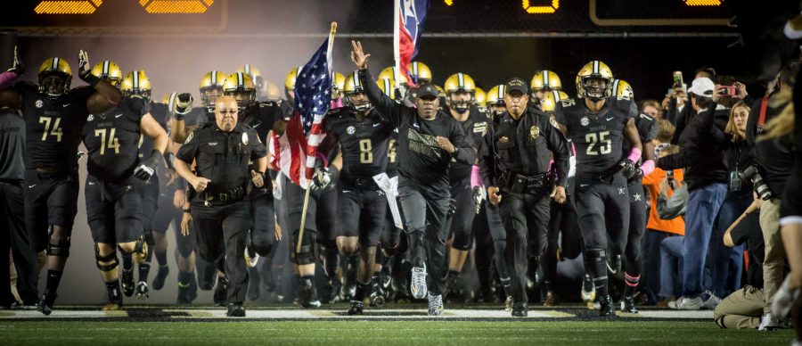 October 22nd, 2016 – Coach Mason leads the Commodores onto the field before their 35-17 win against TSU on Saturday Night at Vanderbilt Stadium. Photo by Blake Dover