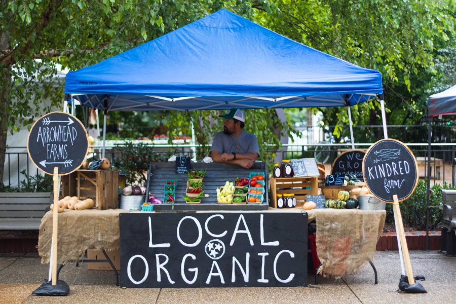 A vendor at the Farmers Market on Thursday August 31, 2017 waits for potential customers.