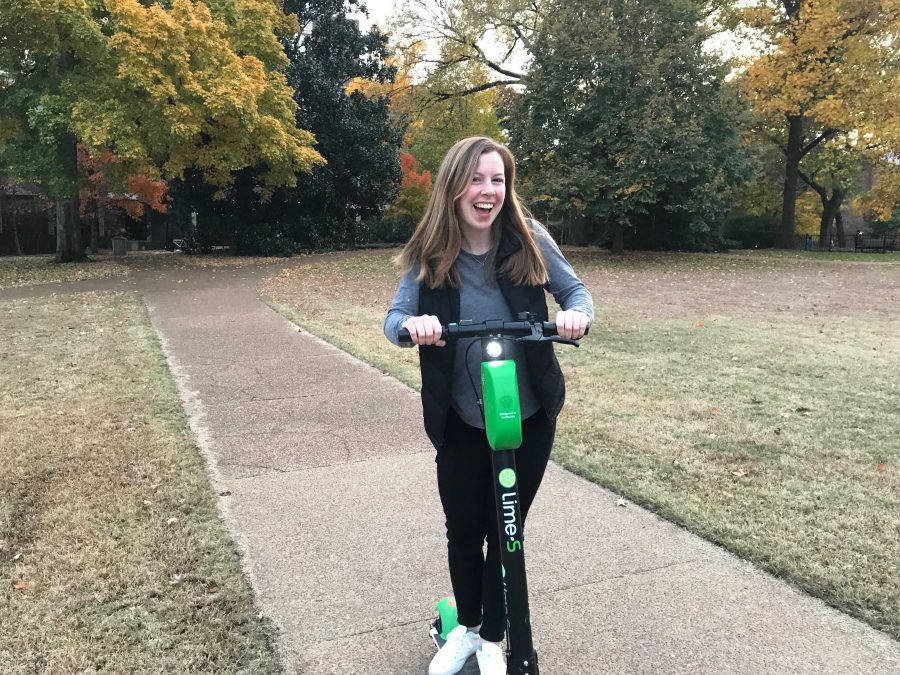 Lila Johnson, Vanderbilt junior, riding a Lime Scooter across Central Library Lawn
