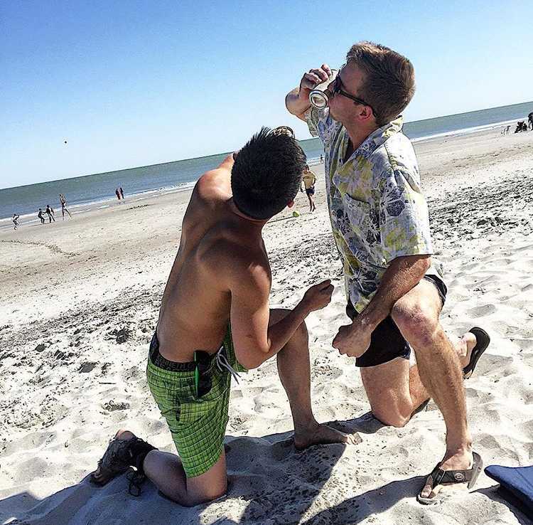Two college students shotgunning beers.