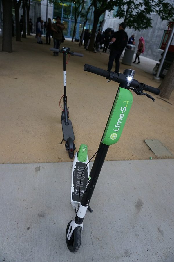 Two electric scooters blocking a path