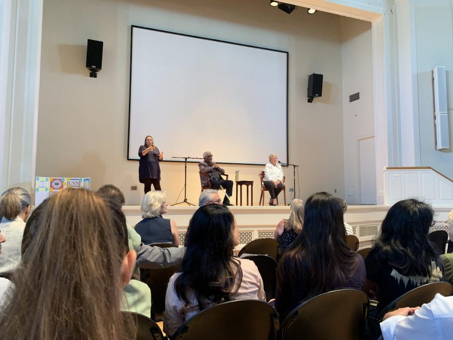 Arun Gandhi on stage with Associate Dean of Human and Organizational Development Sharon Shields and a sign language interpreter in Wyatt Center. (Photo by Immanual John Milton)