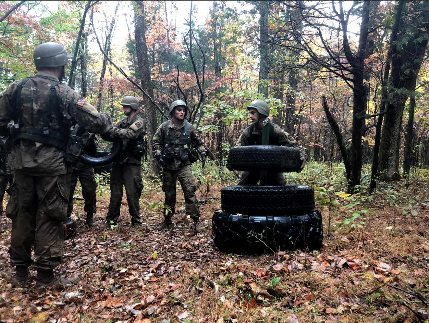 Cadets competing in the “Tower of Tires” challenge, a timed puzzle with strict rules in which numbered tires of varying sizes and weights must be transferred from pillar to pillar (Photo by Thomas Hum)