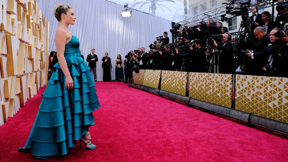 Florence Pugh shines in teal on the red carpet. Photo courtesy BBC
