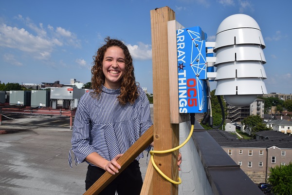Senior Caroline Janssen, who is studying civil engineering, stands with an Array of Things sensor. Sensors like this one are located at the Commons Bridge, by the Baker Building and at the corner of 21st Ave. and Broadway. (Photo courtesy Shun Ahmed, VU Engineering Communications)