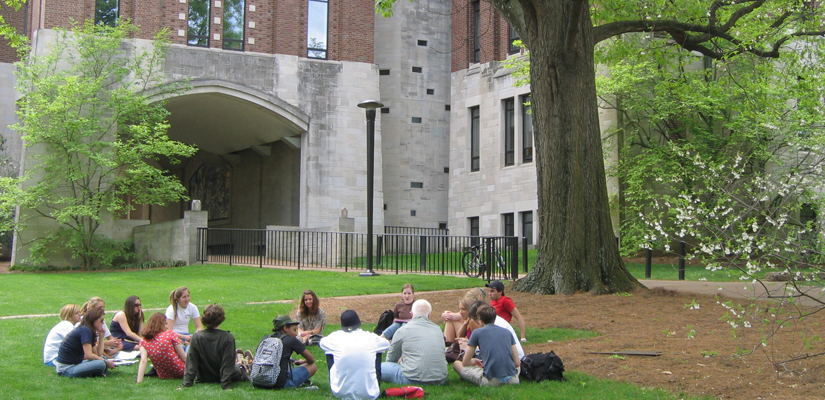 Students sit on lawn outside of Calhoun Hall.