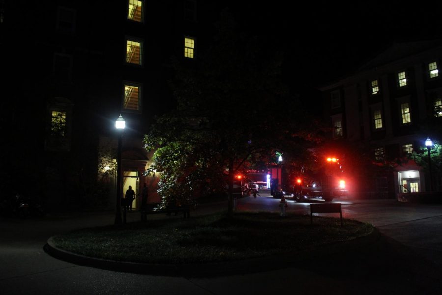 Students stand outside watching as firefighters address a dryer that caught fire in the Crawford laundry room Sept. 27.  (Hustler Multimedia/Geena Han)