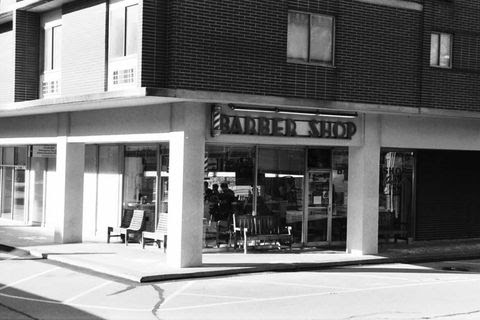 Exterior of Oxford Barber Shop in black and white