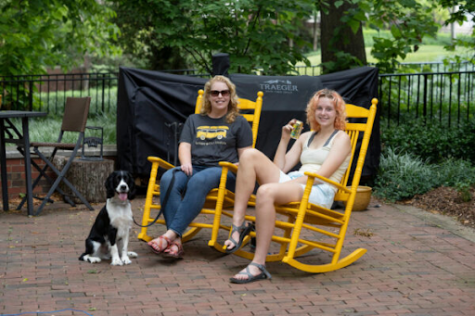 elizabeth pendergrass sitting with her dog and daughter in rocking chairs outside West House