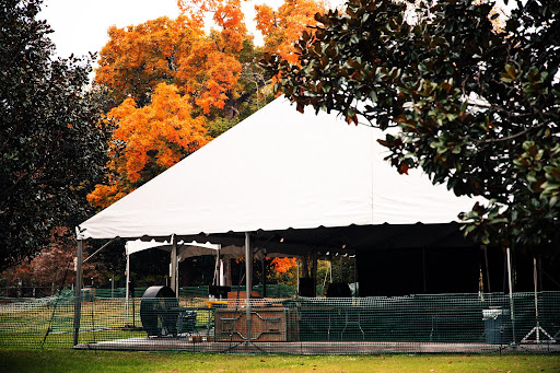tent on library lawn with foliage in the back