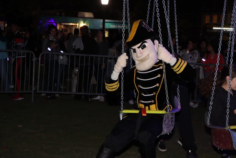 Mr. C riding a swing at the homecoming block party