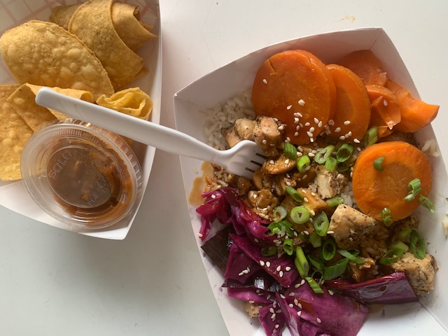 Califarmia Food Truck serves a Chicken Teriyaki Bowl with chips and salsa on Alumni Lawn. 
