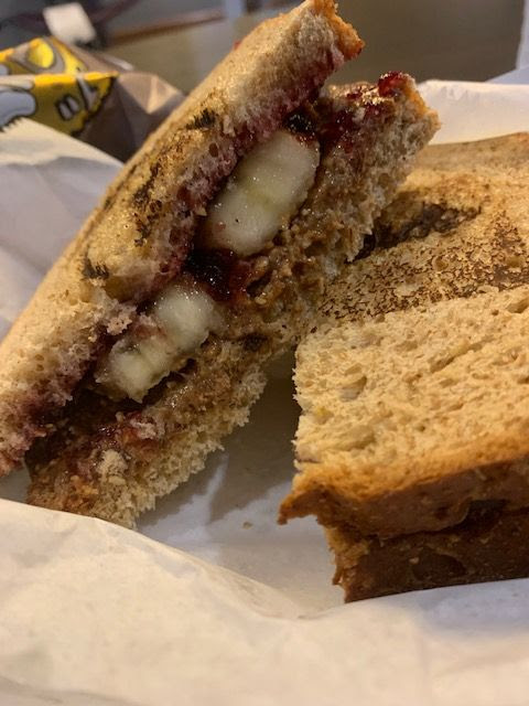 The Health Nut sandwich from Spread’Em includes whole wheat bread filled with almond butter, crunchy granola, grape jelly and banana slices. (Hustler Staff/Veronica Tadross) 