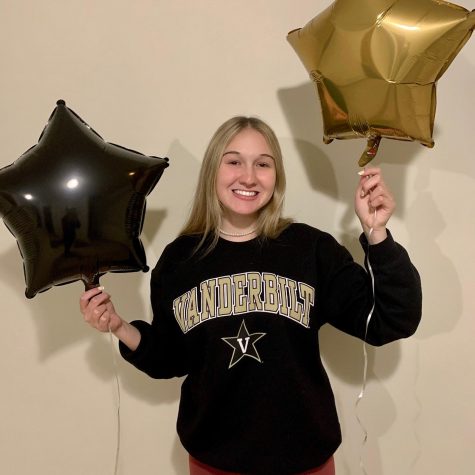 Eva Mckinzie holding balloons to celebrate her acceptance to Vanderbilt