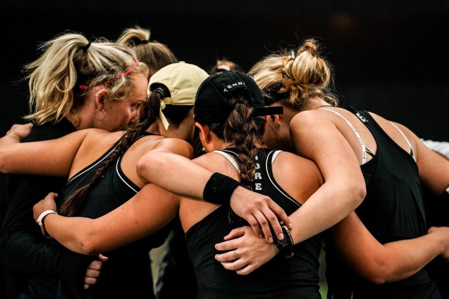 Vanderbilt womens tennis huddles during a match in the 2021-22 season.