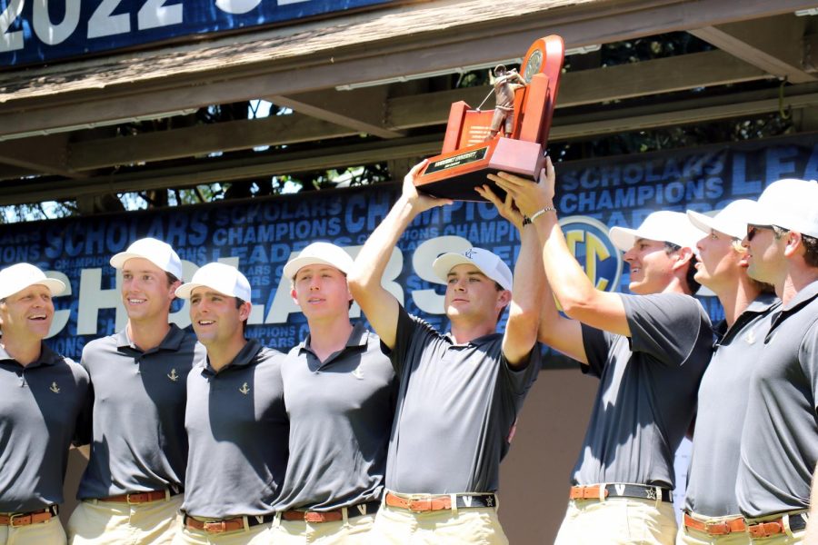 Vanderbilt mens golf holds up their SEC Championship trophy on April 24, 2022.