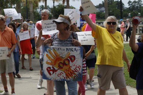 Protesters raise signs with the names of victims from recent shootings as they march in Myrtle Beach, as photographed on June 11, 2022. (Hustler Multimedia/Barrie Barto)