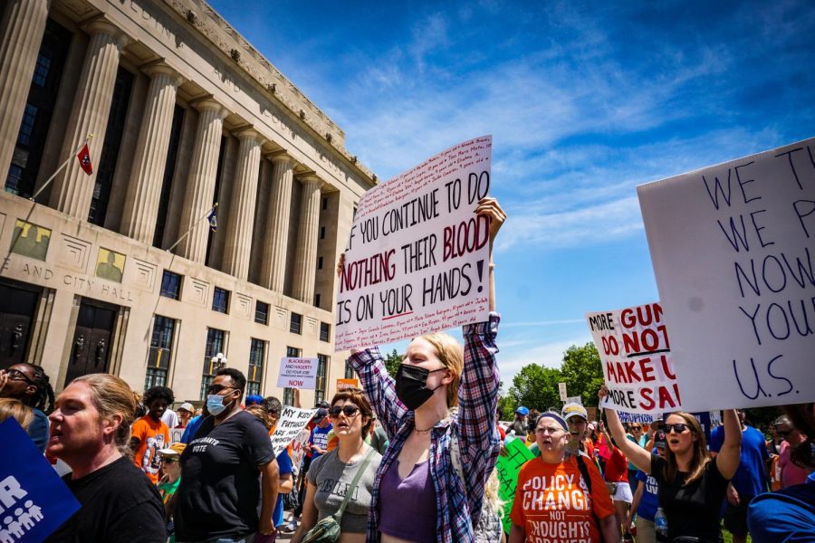 Vanderbilt Student Payton Breitzmann carries a sign with the names of the Uvalde shooting victims, captured on June 11, 2022. (Hustler Multimedia/Miguel Beristain)