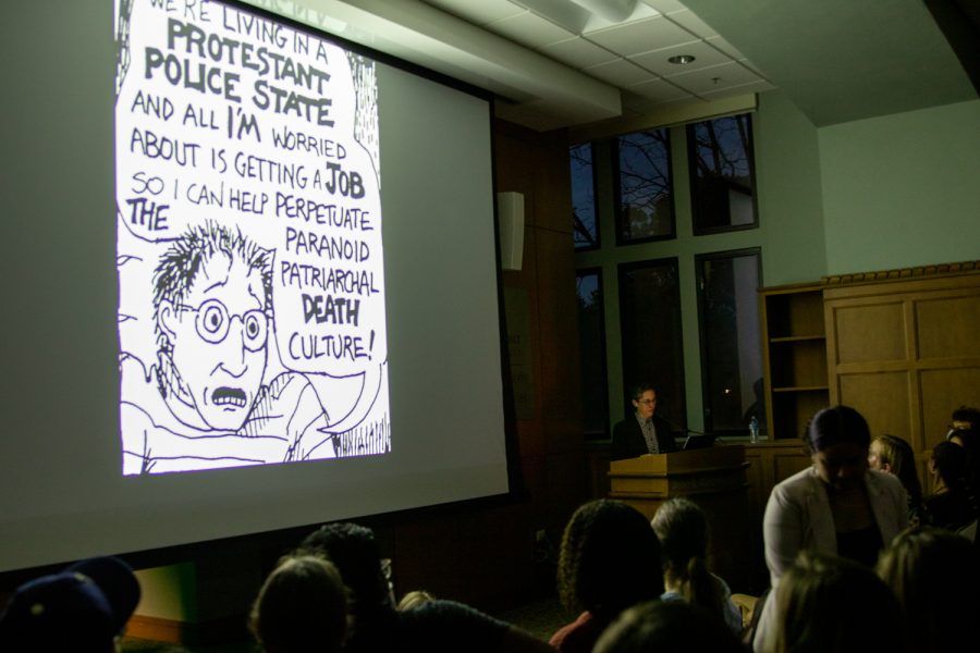 Alison Bechdel shares one of their political cartoons with the audience, as photographed on Nov. 7, 2022. (Hustler Multimedia/Barrie Barto)