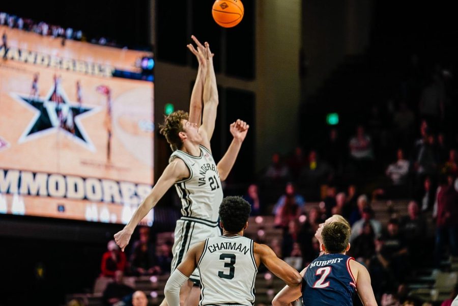 Liam Robbins jumps for the opening tip against Belmont in the NIT (Hustler Multimedia/Miguel Beristain)