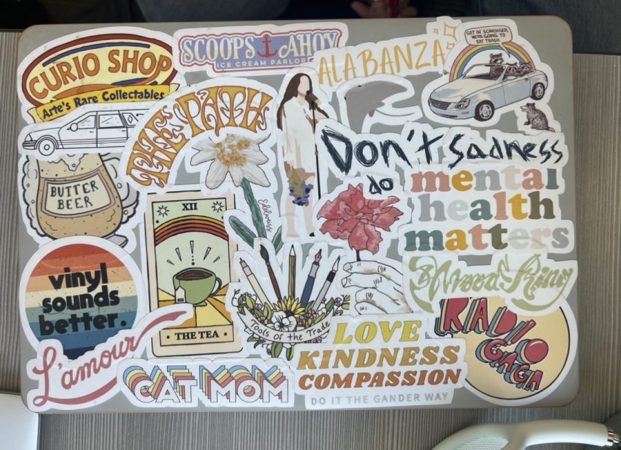 A student laptop with many curated stickers, as photographed on Jan. 20, 2023. (Hustler Staff/Blythe Bouza)