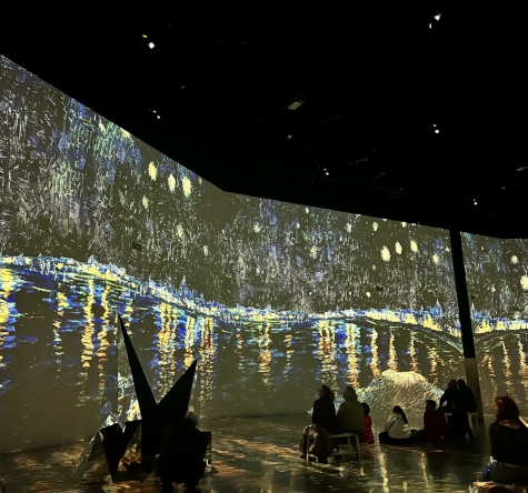 An audience watches Van Gogh’s “Starry Night over the Rhone” come to life via digital art, as captured on Dec. 16, 2022. (Hustler Staff/Isabella Bautista)