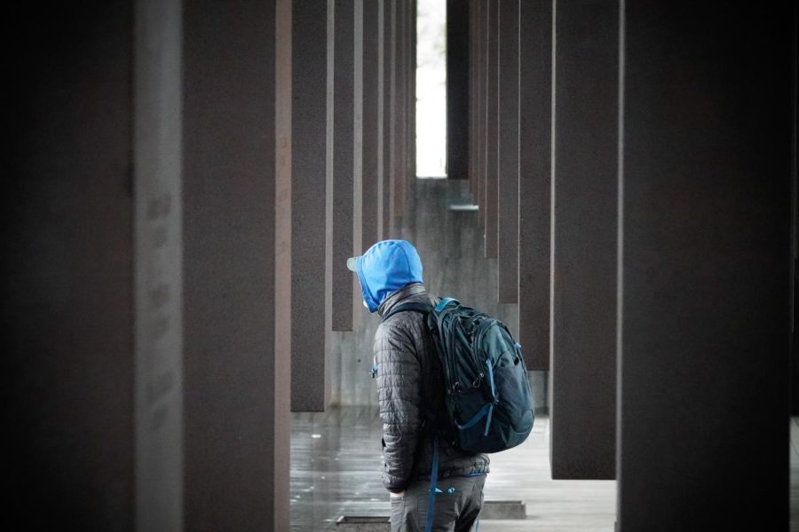 Visitor exploring the columns engraved with the names of lynching victims from different counties, at the National Memorial for Peace and Justice in Montgomery, Alabama, photographed Feb. 11, 2023. (Hustler Multimedia/Sean Onamade)