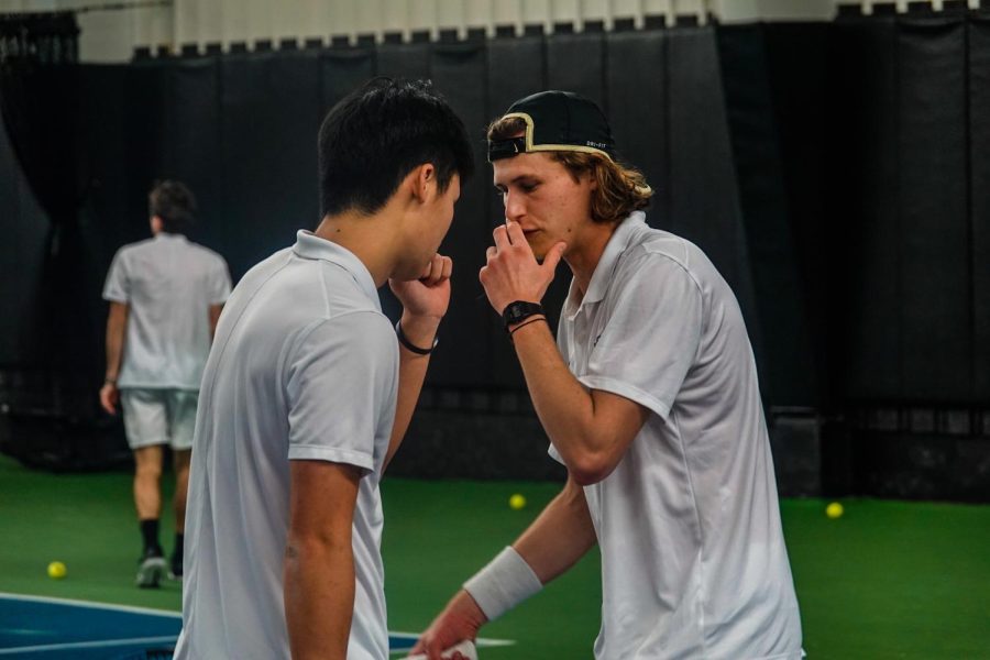 Men’s tennis players discuss strategy against Princeton on Feb. 4, 2023.