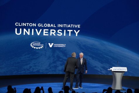 Chancellor Daniel Diermeier and former president Bill Clinton shake hands on stage, as photographed on March 3, 2023. (Hustler Multimedia/Tasfia Alam)