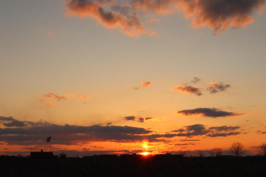 The sun sets over a Pennsylvania cornfield, as photographed on March 18, 2023. (Hustler Staff/Isabella Bautista)	
