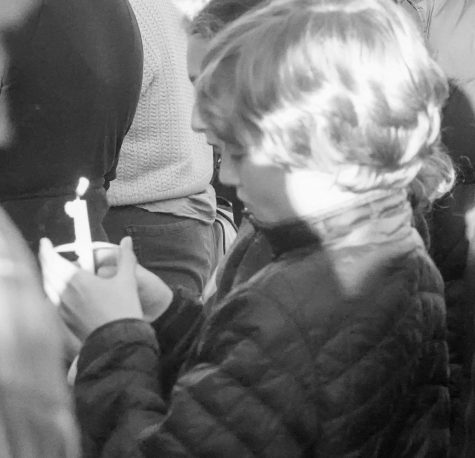 A child holds his candle at the vigil, as photographed on March 29, 2023. (Hustler Multimedia/Barrie Barto)
