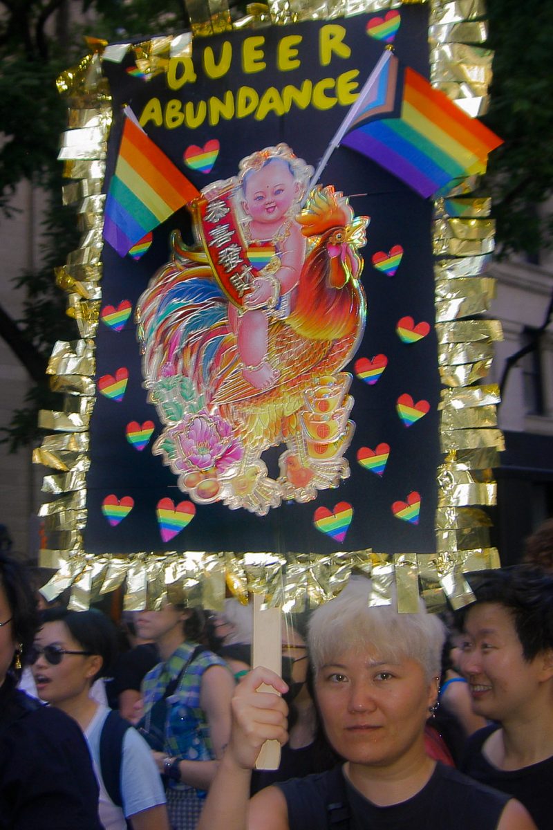 A member of Q-Wave, an LGBTQ+ and Asian identity group, holds up a sign at the Dyke March, as photographed on June 24, 2023 (Hustler Staff/Katherine Oung)
