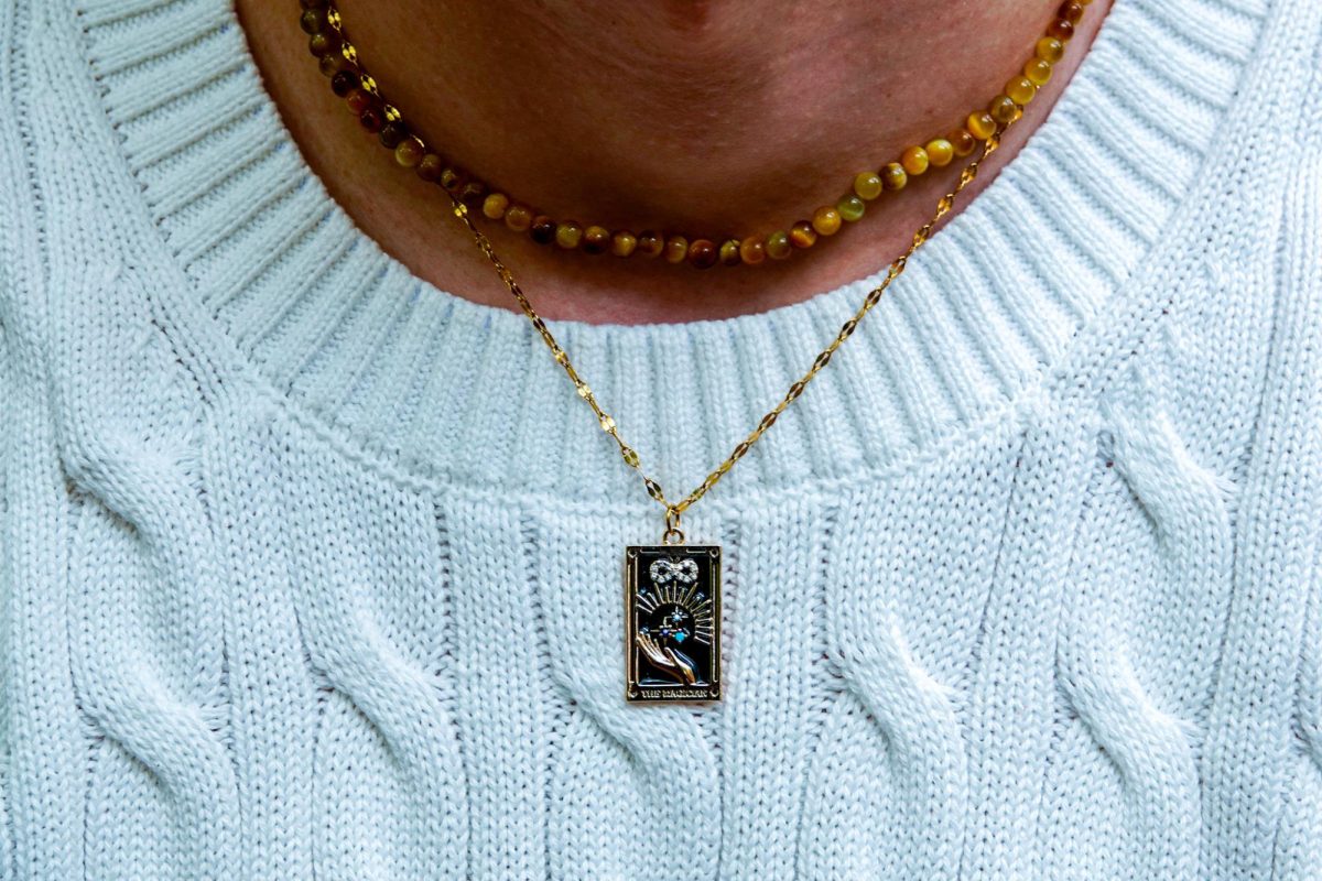 Nate Morrin shows off their tarot card necklace, as captured on Sept. 8, 2023. (Hustler Multimedia/Ankit Janamanchi)
