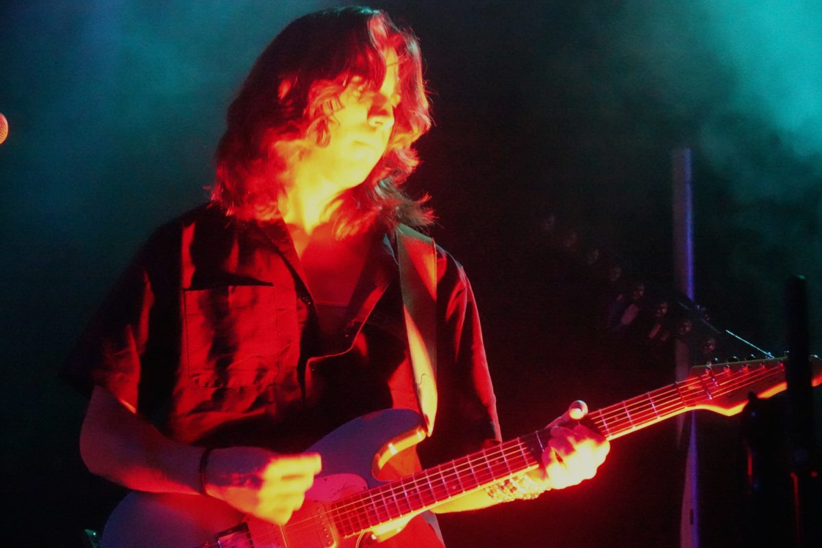 Moontower guitarist, Devan Walsh, covered in orange light, as photographed on Sept. 8, 2023. (Hustler Multimedia/Megan Landis)

