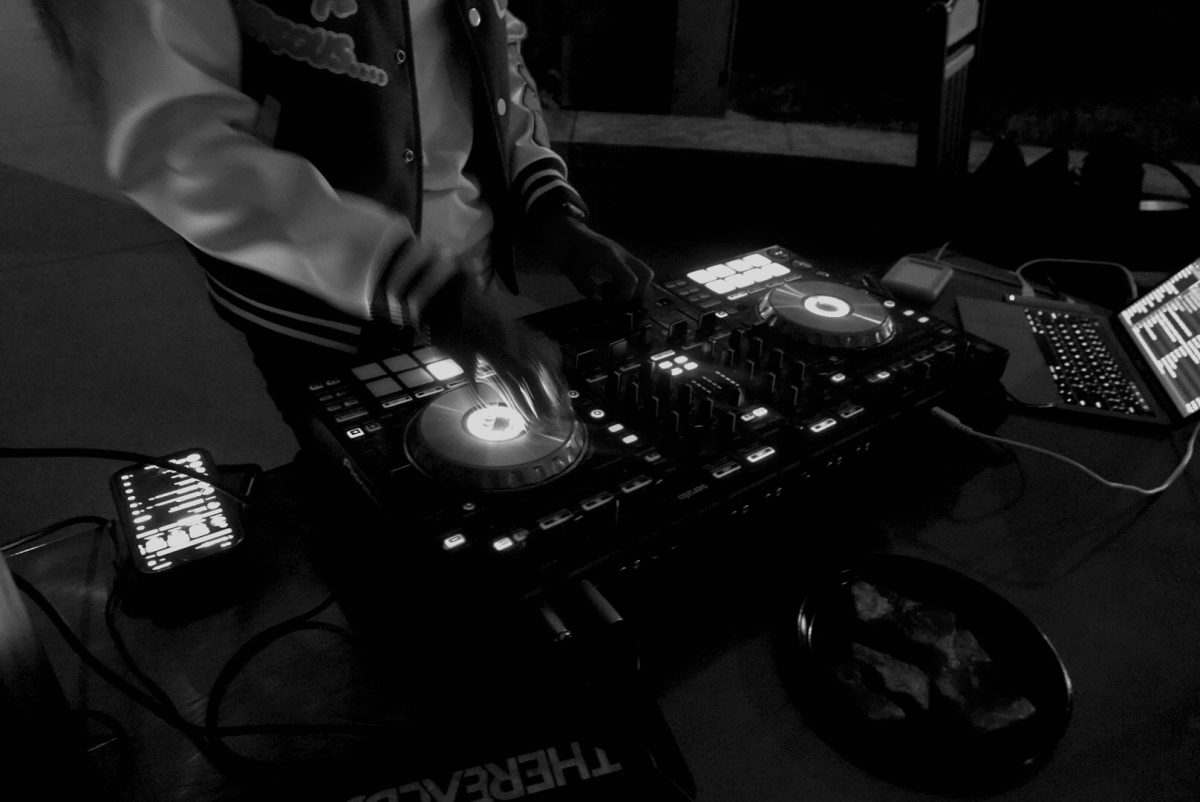 DJ turns a disc on the turntable as the party ramps up, as captured on Oct. 13, 2023. (Hustler Multimedia/George Albu)
