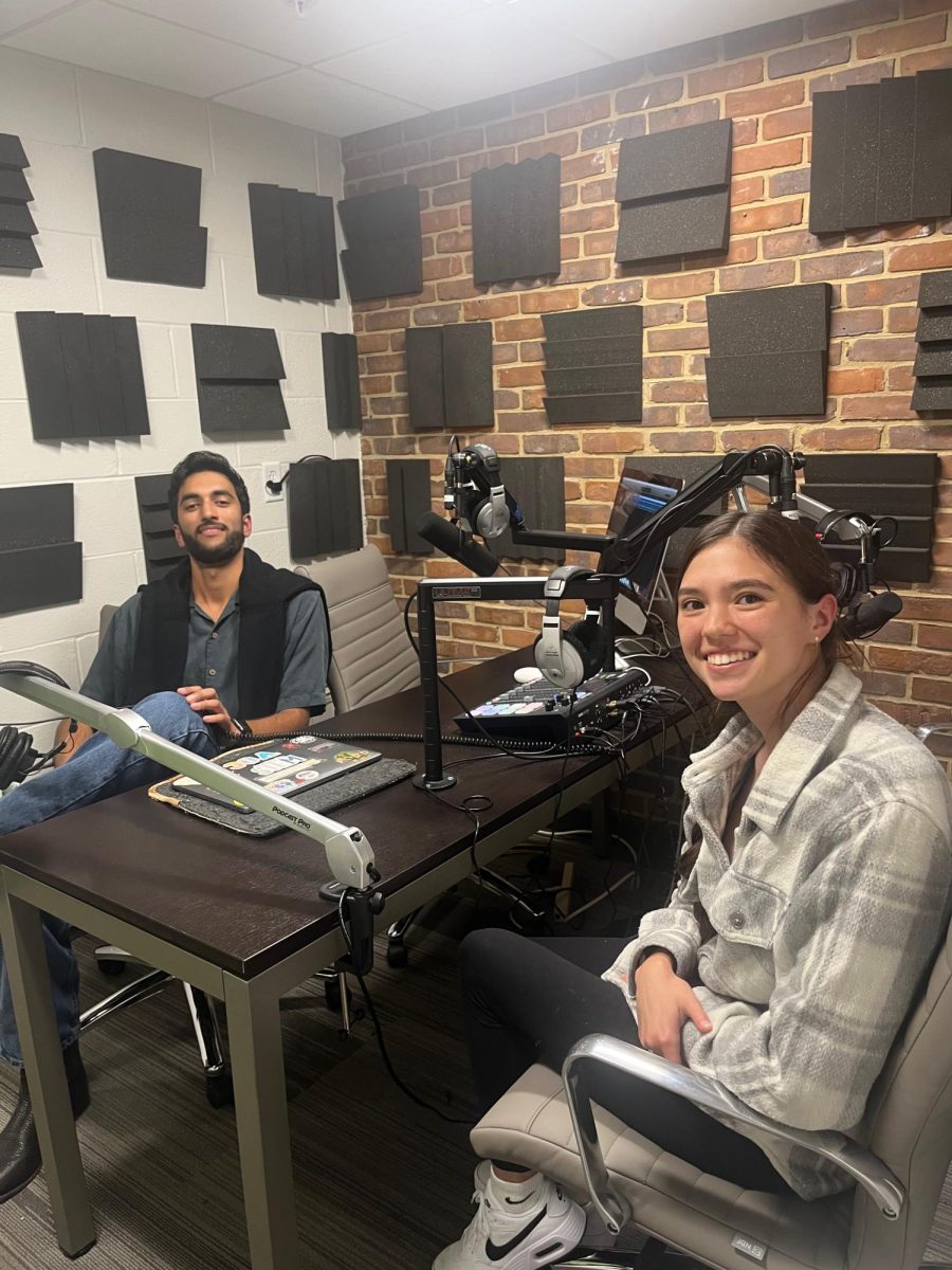 photo of Farouk Ramzan and Katey Parham sitting in a podcasting studio