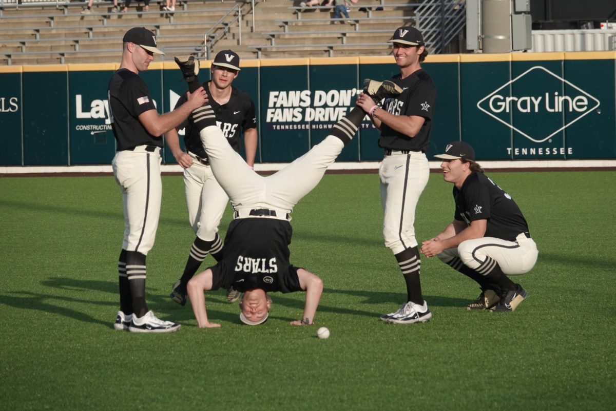 Vanderbilt baseball player stands on his head in the outfield, as photographed on Nov. 12, 2023 (Hustler Multimedia/Ashley Hofflander)