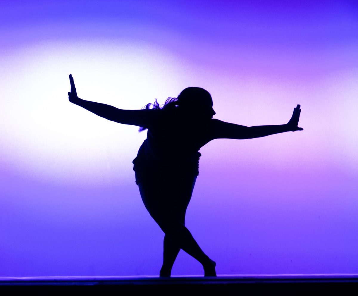Silhouette of Vitality member performing on the Langford Auditorium stage, captured on Nov. 10, 2023. (Hustler Multimedia/Bella Guzman)