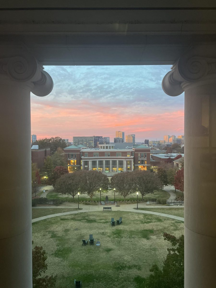 Commons Center underneath colorful sky framed by Stambaugh House balcony pillars, as photographed on Nov. 14, 2023. (Hustler Multimedia/Ava Aria)