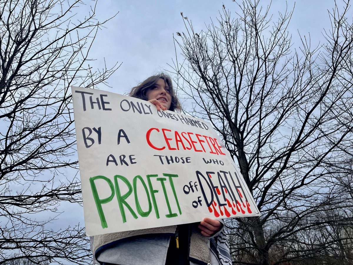 A protester holds a sign at the rally, as photographed on Feb. 4, 2024. (Hustler Multimedia/Tasfia Alam)