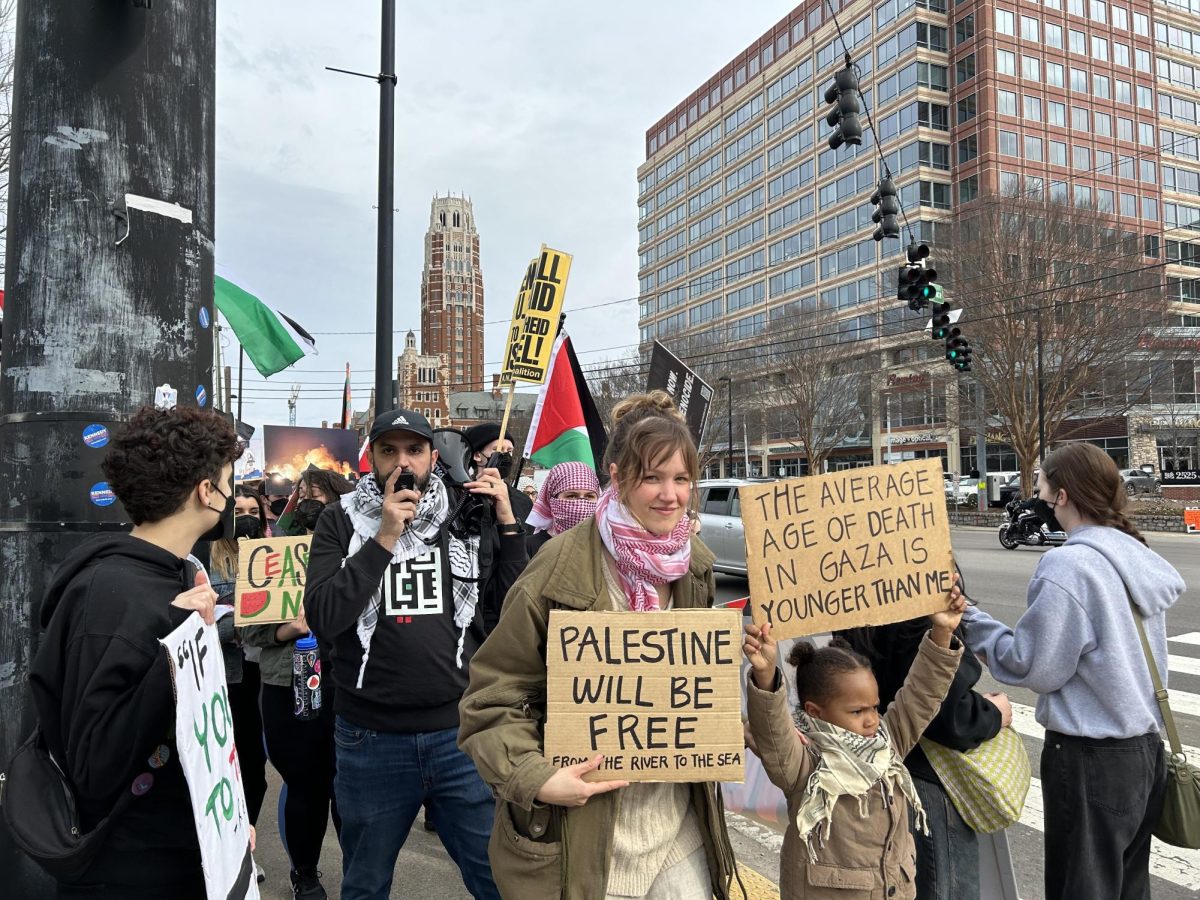 A child holds a sign with protesters as they march on West End Ave., as photographed on Feb. 4, 2024. (Hustler Multimedia/Alison Winters)