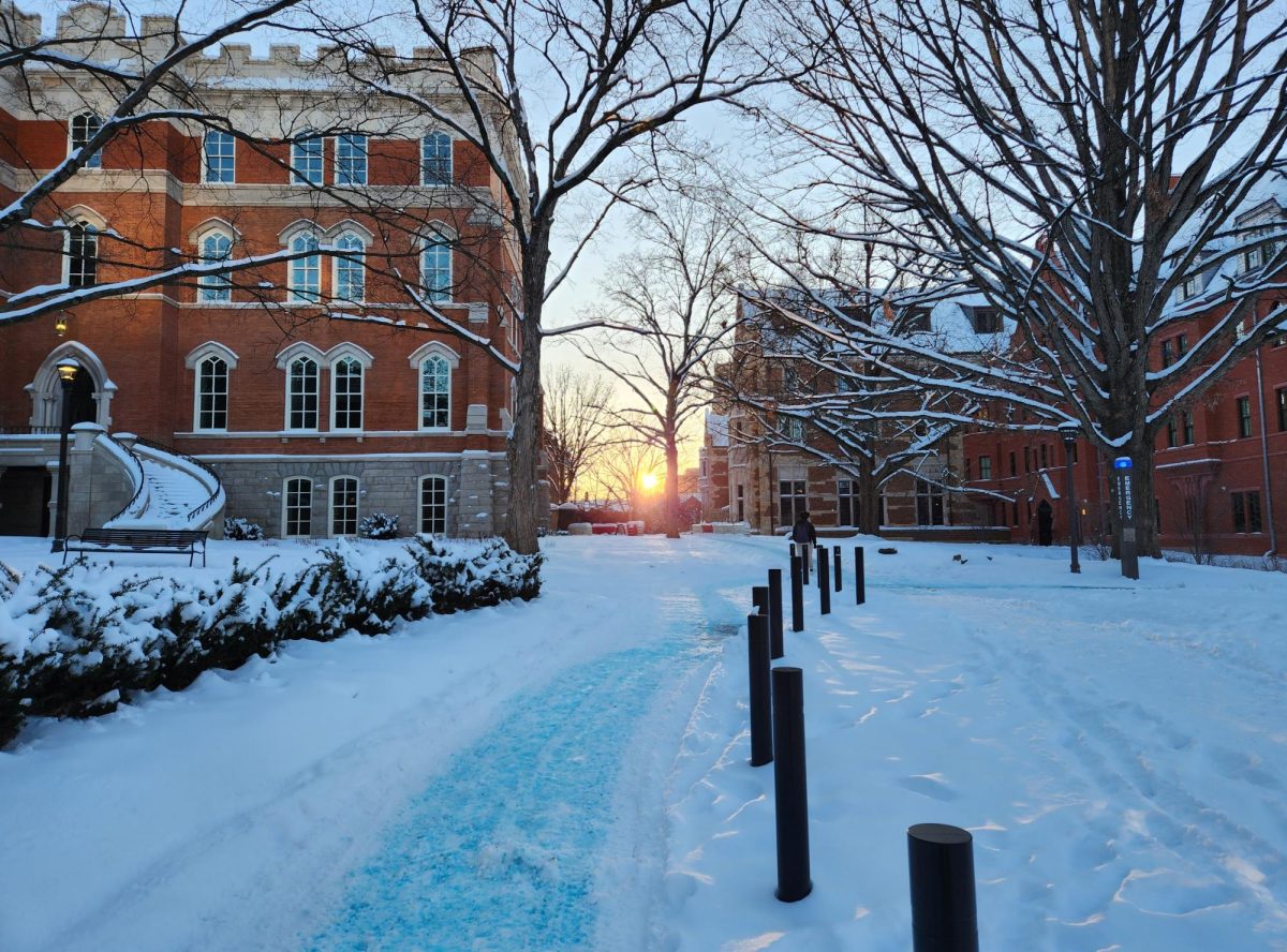 The sun shines through a gap between Kirkland Hall and EBI on a snowy day, as photographed on Jan. 16, 2024. (Hustler Multimedia/Alice Tang)