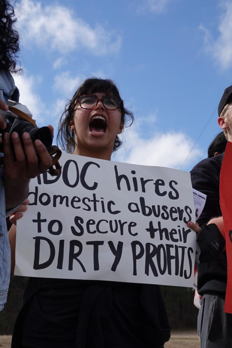 Protesters hold up a sign in protest against ADOC allowing officers to remain on payroll following assault indictment, as photographed on March 2, 2024. (Hustler Multimedia/Harmony Wang)