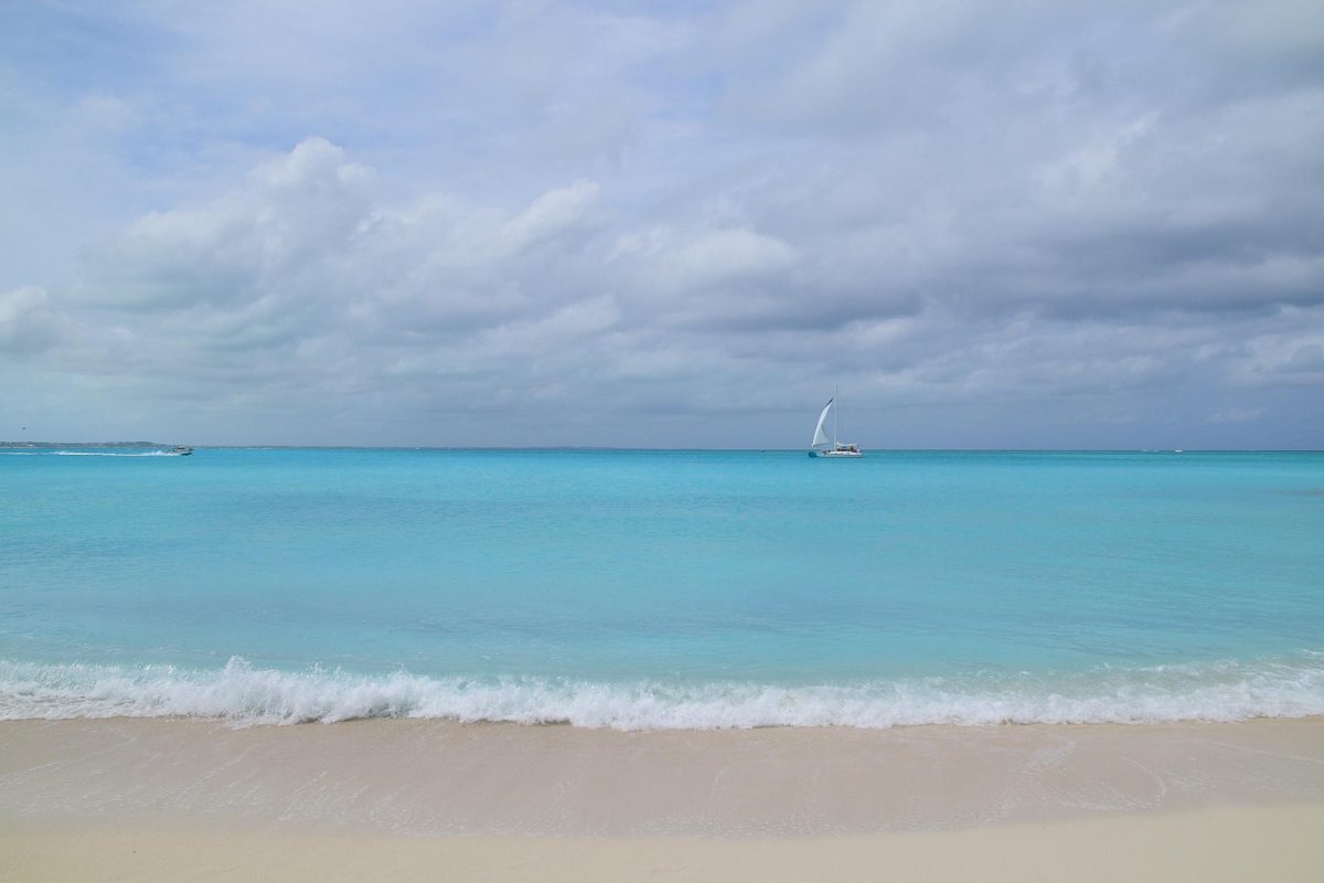 Boats pass by on Grace Bay Beach, as photographed on March 15, 2024. (Hustler Multimedia/Alondra Moya)