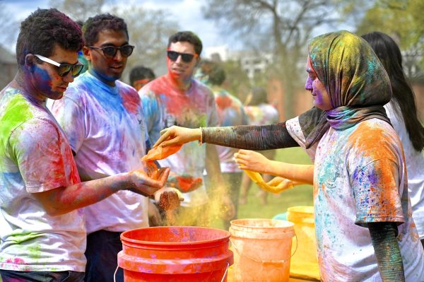Student distributes colorful powder to celebrate Holi, as photographed on March 31, 2024. (Hustler Multimedia/Alysa Suleiman)