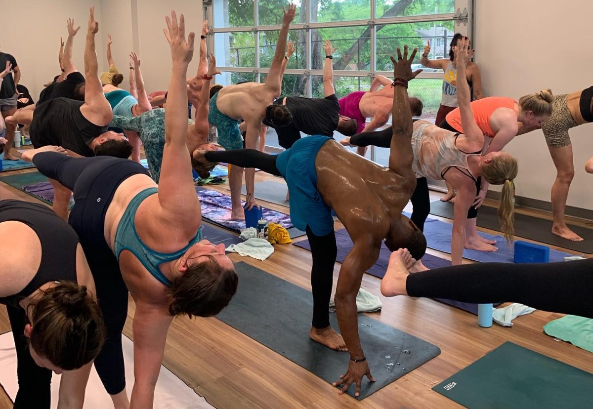 Participants of a hot yoga class at Small World Yoga strike a pose. (Photo courtesy of Small World Yoga).
