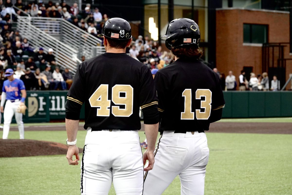 Jonathan Vastine and coach at first base, as photographed on April 19, 2024. (Hustler Multimedia/Chloe Pryor)