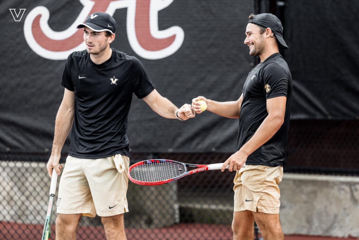 Vanderbilt's Nathaniel Cox and Michael Ross fist bump during a match. As photographed on September 14, 2024. (Vanderbilt Athletics)