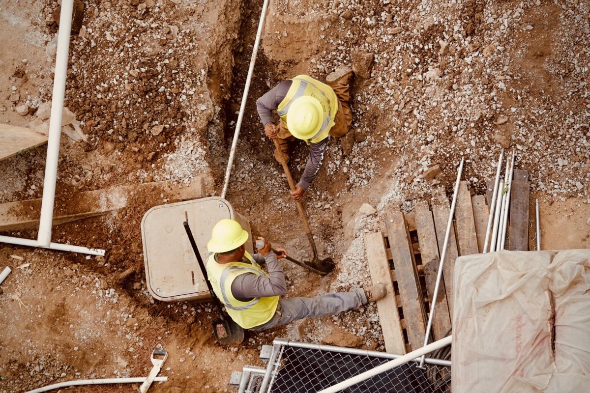 Two workers attempt to excavate earth near FirstBank Stadium, as captured on Sept. 30, 2024. (Hustler Multimedia/Royce Yang)