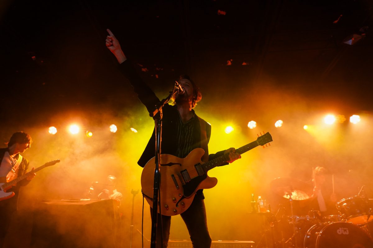 Lead singer Nic Cester finishes the band’s song with band member Cameron Muncey and drummer Chris Cester in the background 